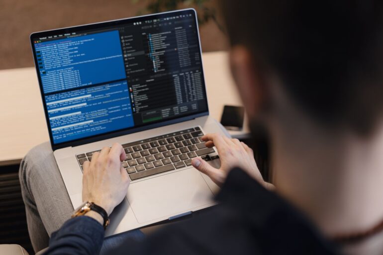 A man coding on his laptop