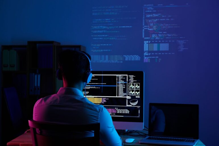 A programmer coding on his computer