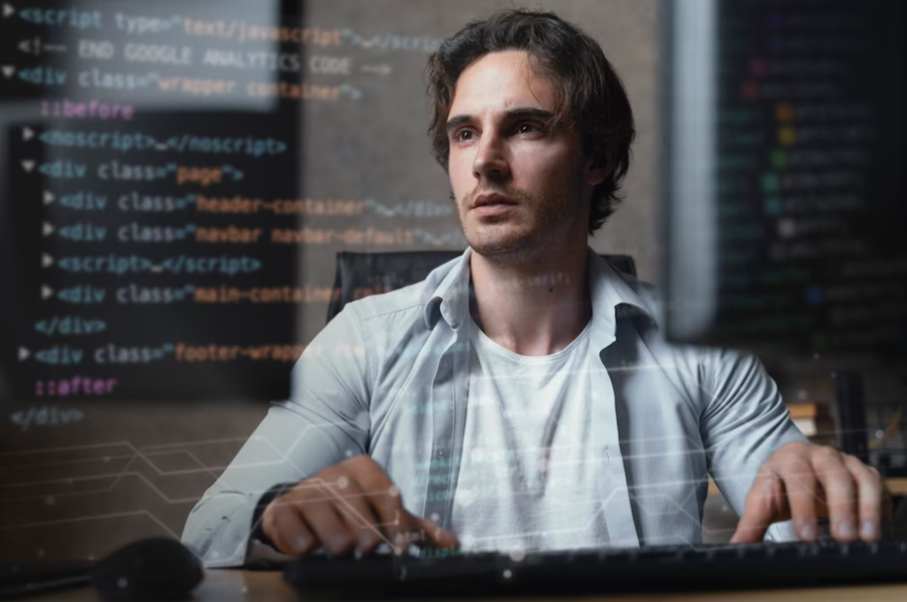 man typing on computer coding