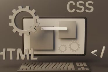 Web page programming elements next to computer