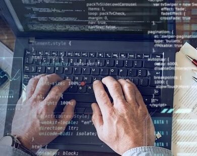 Man typing program code on computer