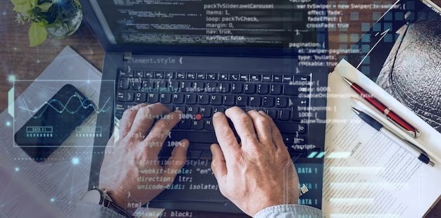 Man typing program code on computer