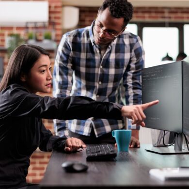 A woman and a man in front of a computer